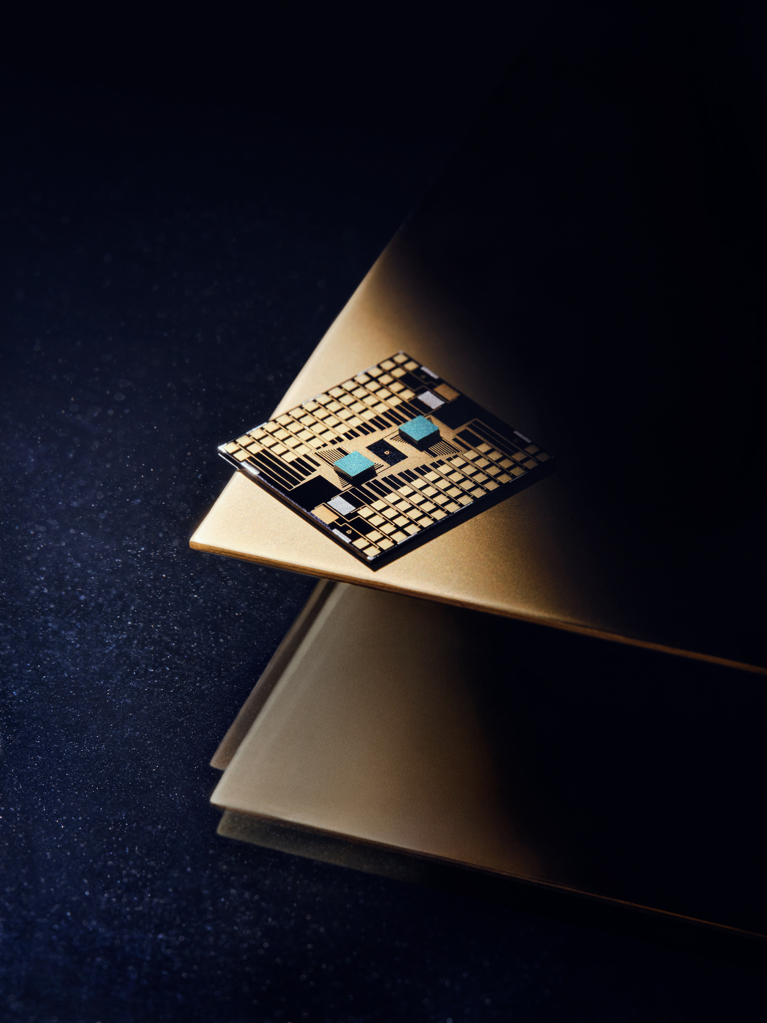 SemiQon quantum chip resting on a gold-toned surface under a spotlight